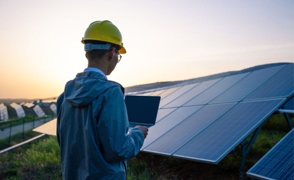 engineer-working-with-a-laptop-in-solar-power-station-picture-id1318137489.jpg